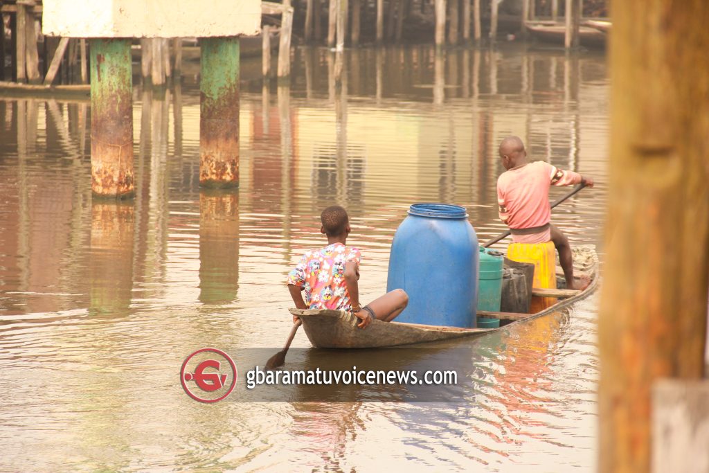 A VIEW OF THE NIGER DELTA THROUGH THE LENS - A picture of children who canoed to fetch water in oil-rich Polobubo community